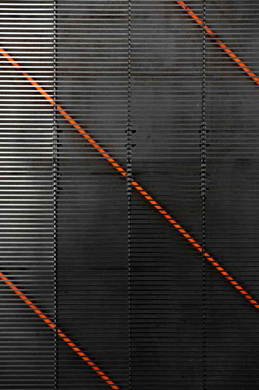 a black wall with orange lines on it
