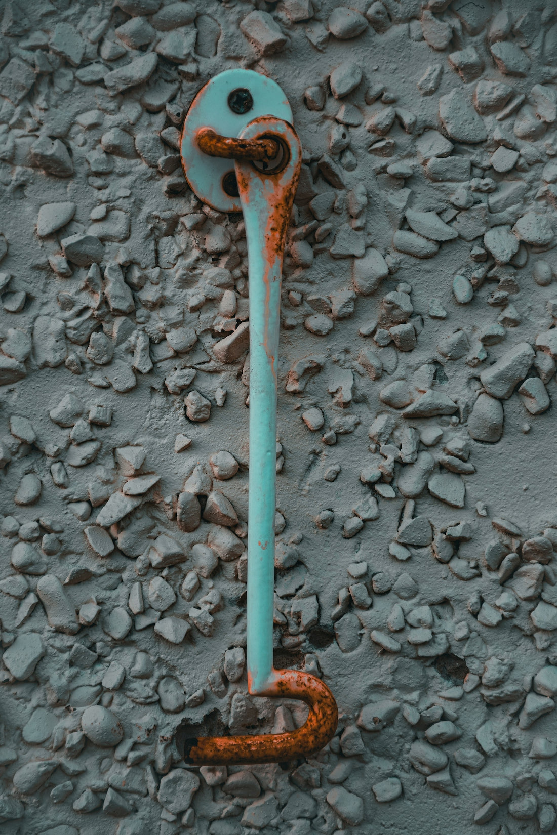 a rusted pipe on the side of a building