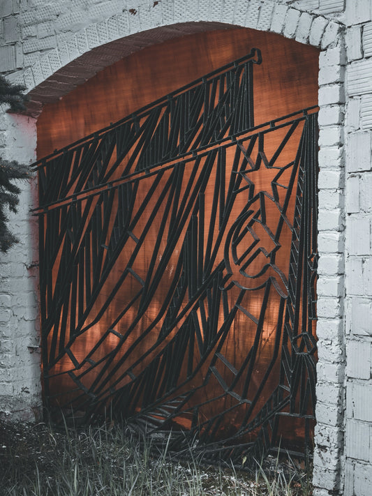 a metal gate with a horse drawn on it