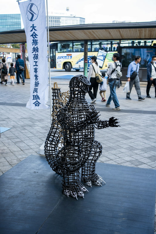a sculpture of a man with a guitar on a sidewalk