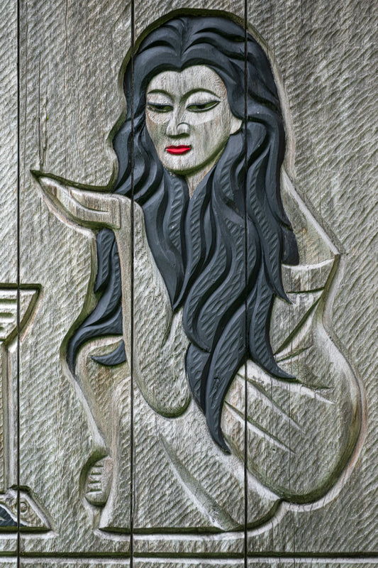 A painting of a woman sitting on a bench