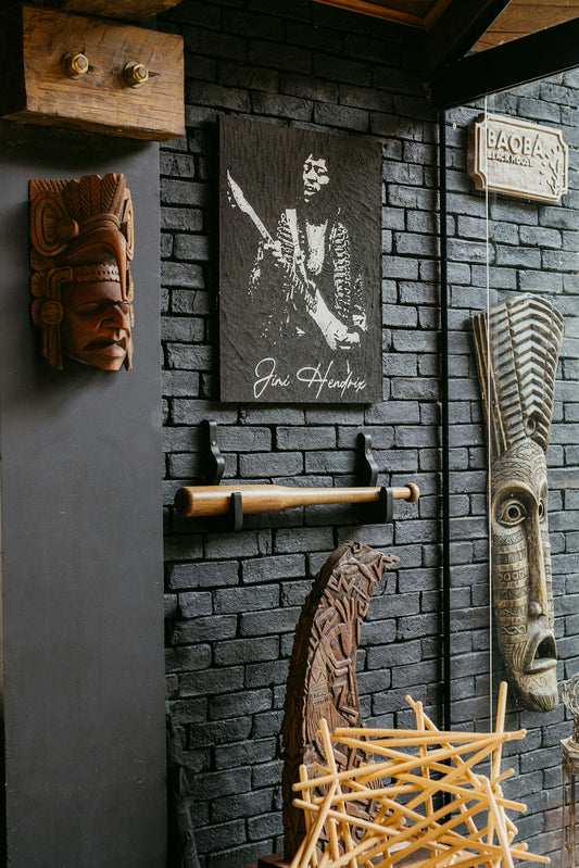 A room with a brick wall and wooden sculptures