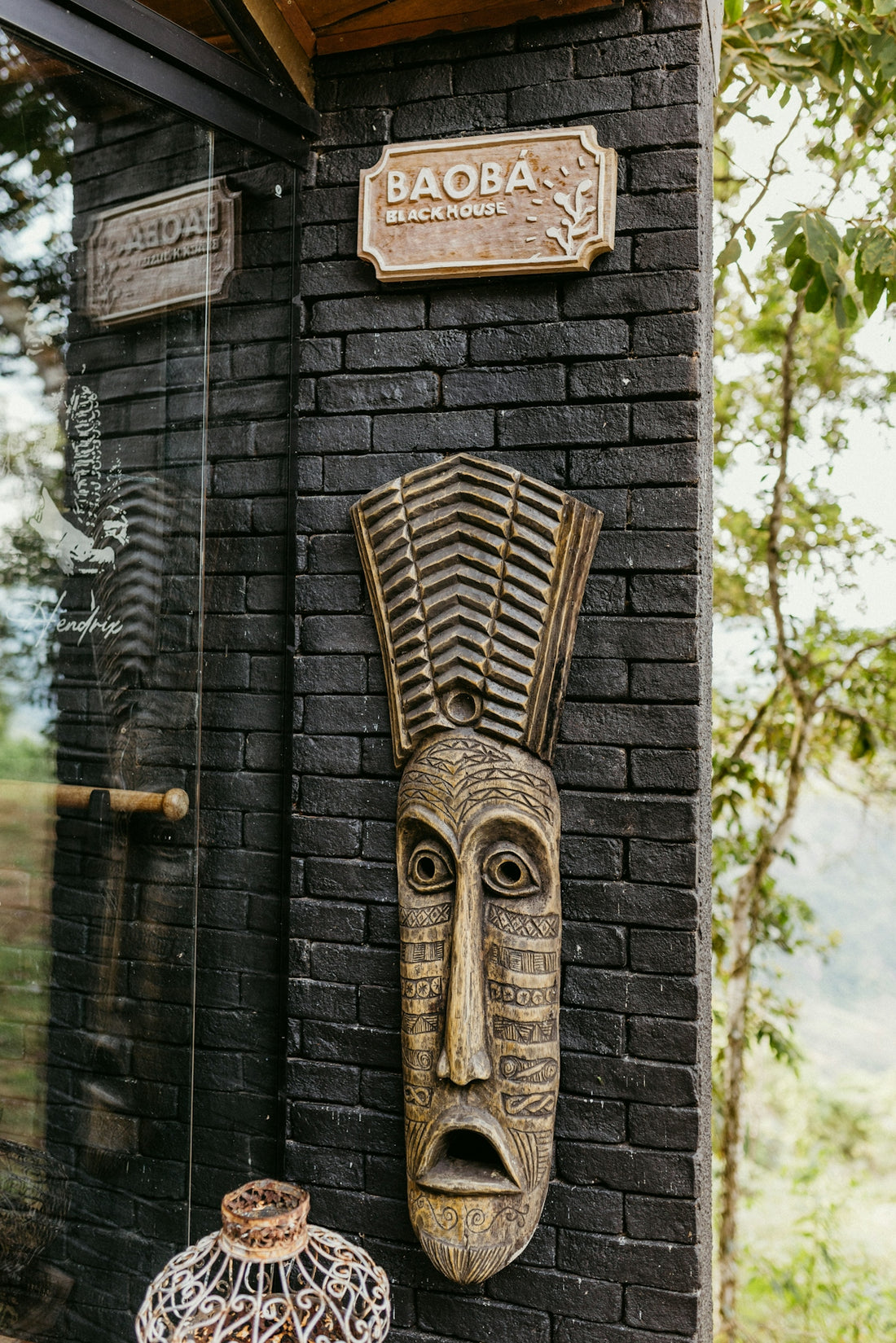 A brick wall with a carved face on it
