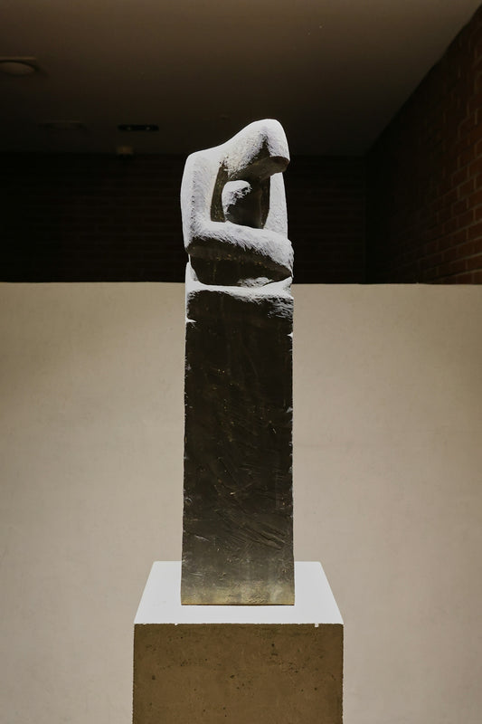 A mother holds her child in a sculpture.