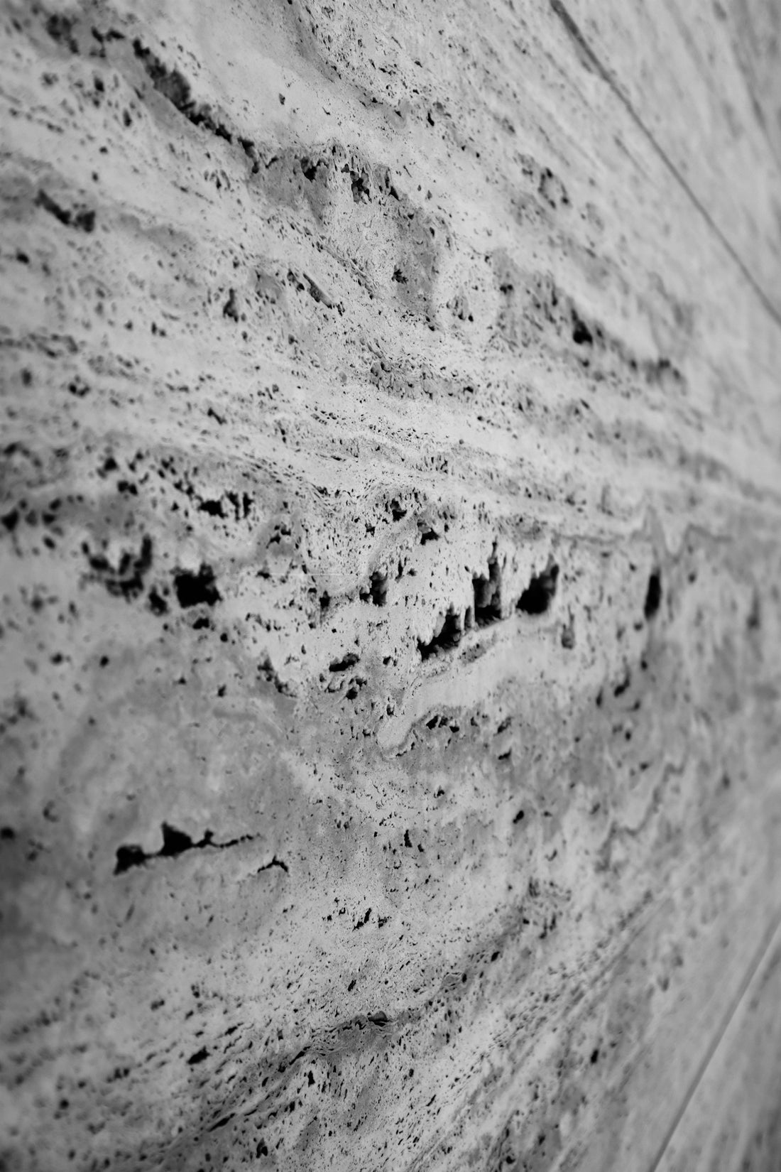 a black and white photo of a stone wall