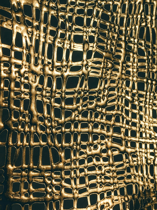 a close up of a wall made of gold foil