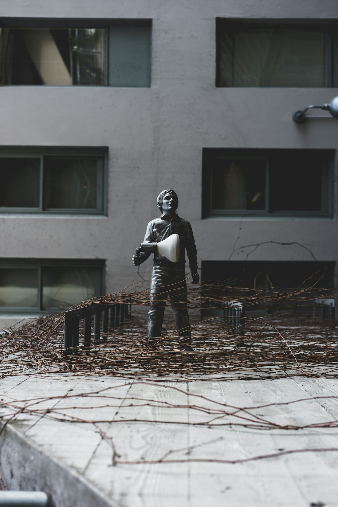 person standing outside black statue