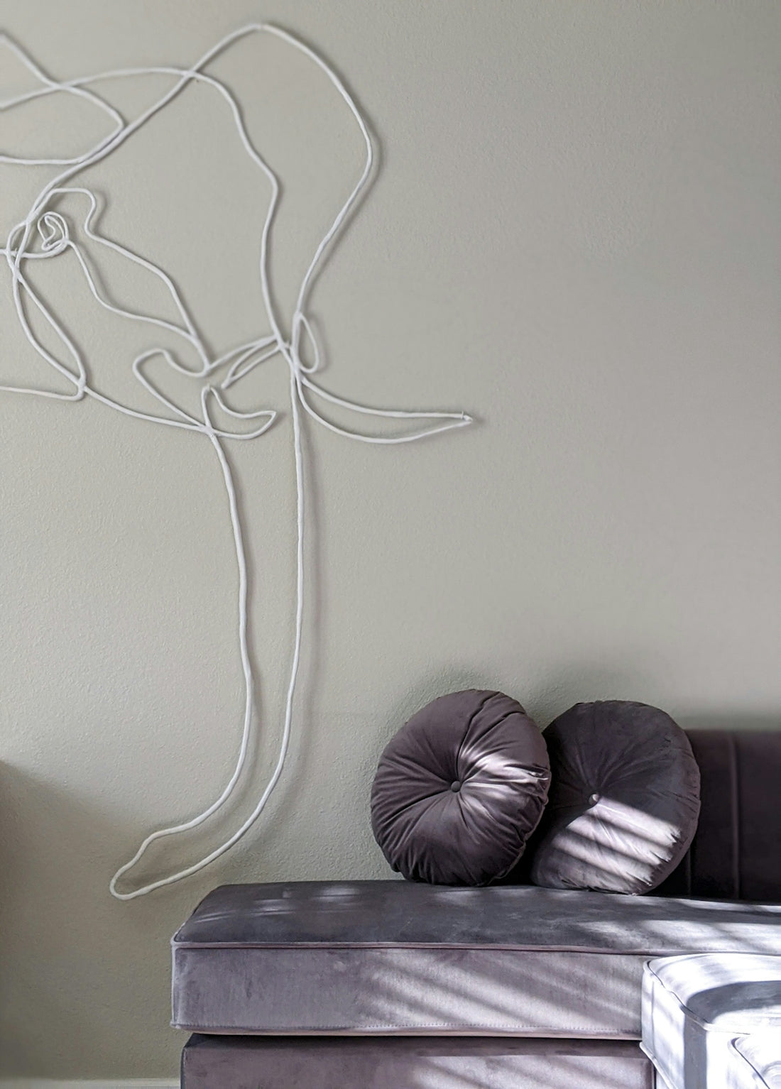 black leather sofa beside white wall