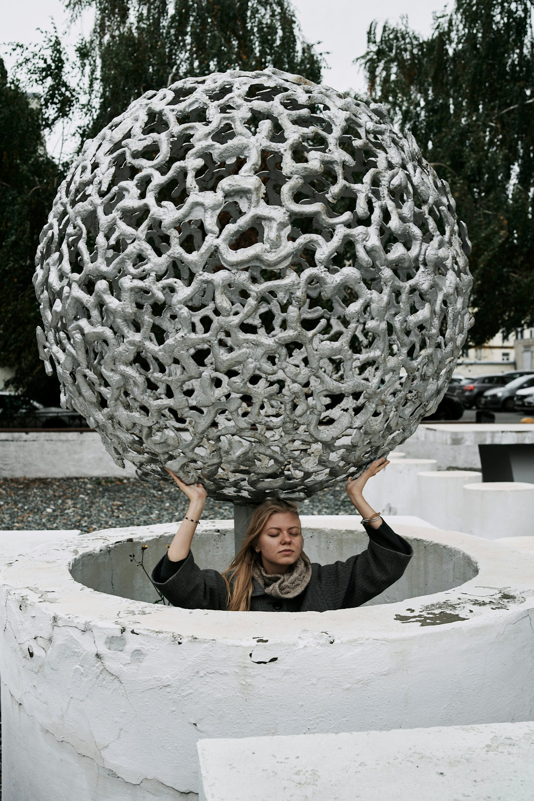 a woman holding a large metal object over her head