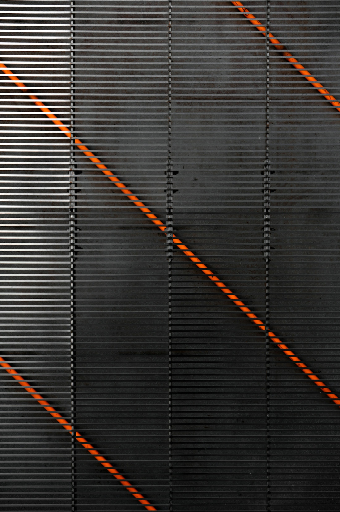a black wall with orange lines on it
