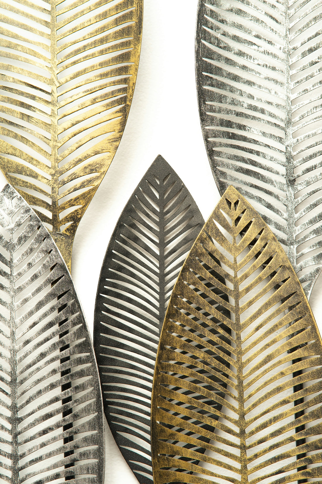 a group of metal leaves on a white background