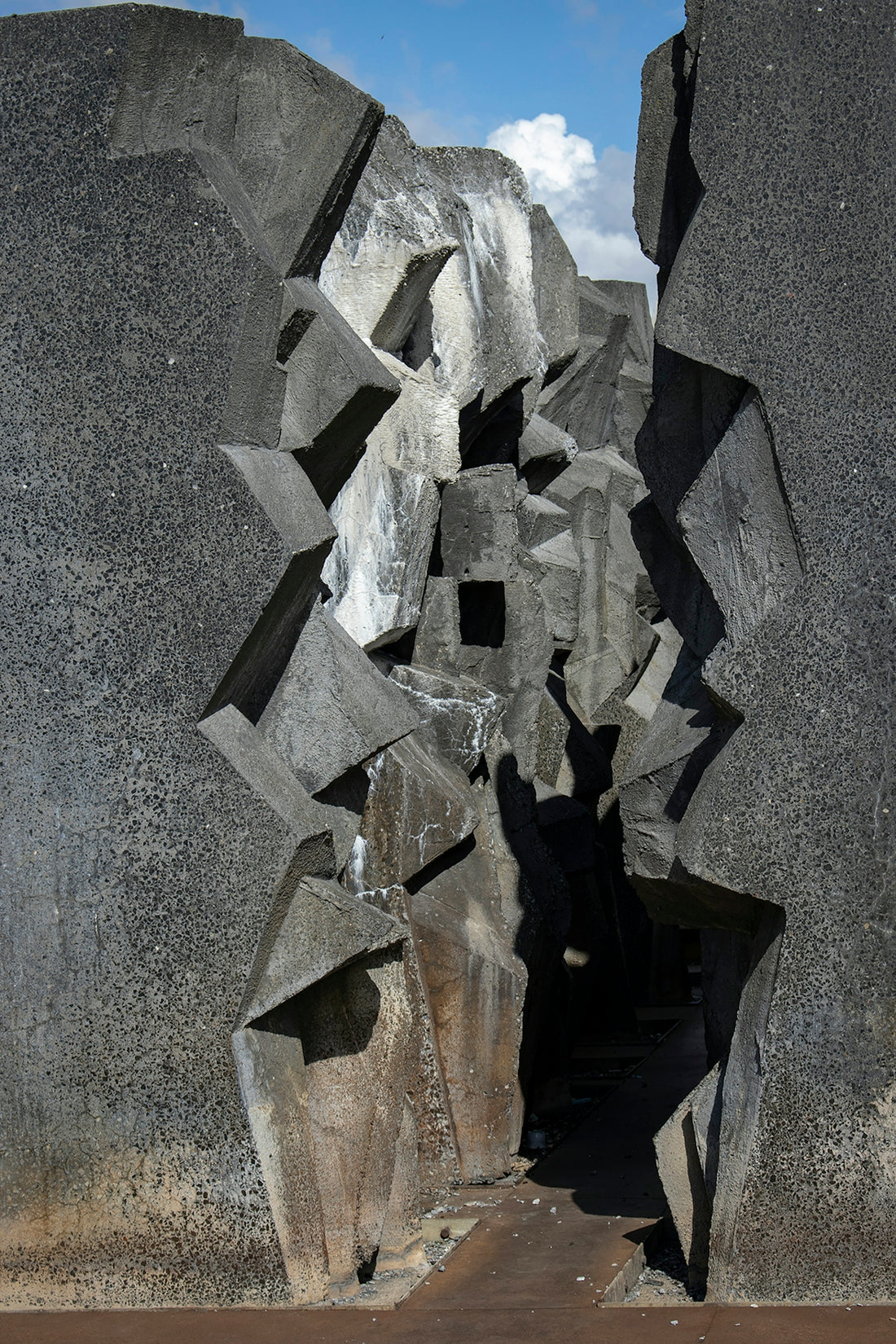 a large rock formation with a sky in the background