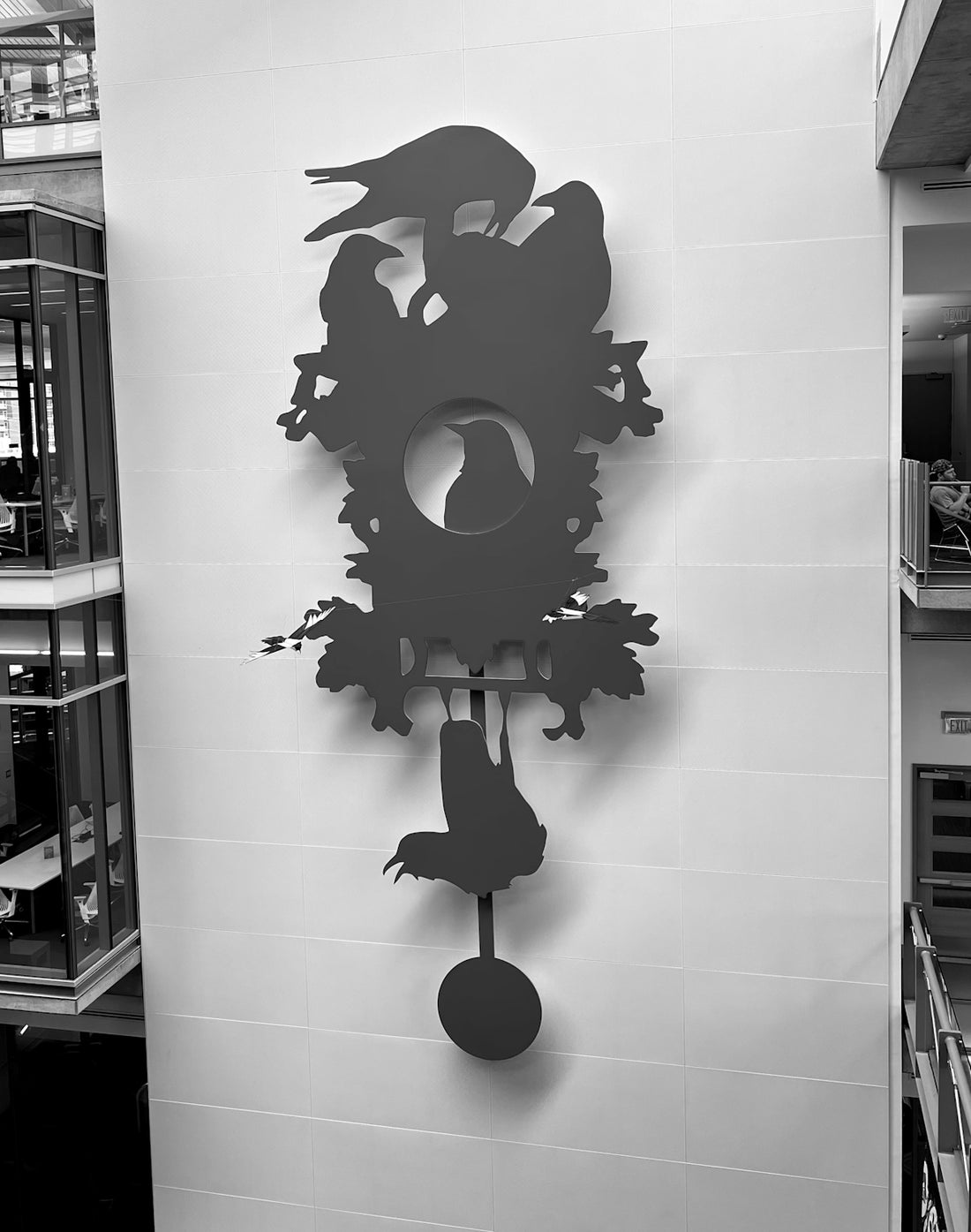 a black and white photo of a clock on a wall