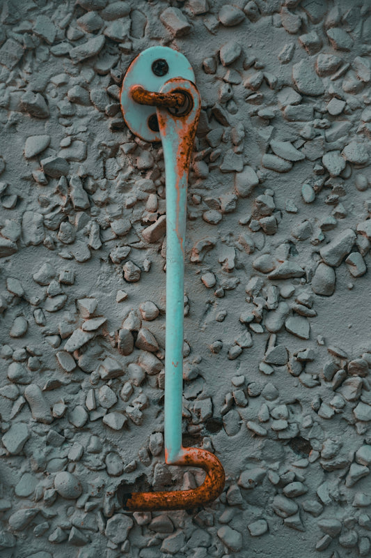 a rusted pipe on the side of a building