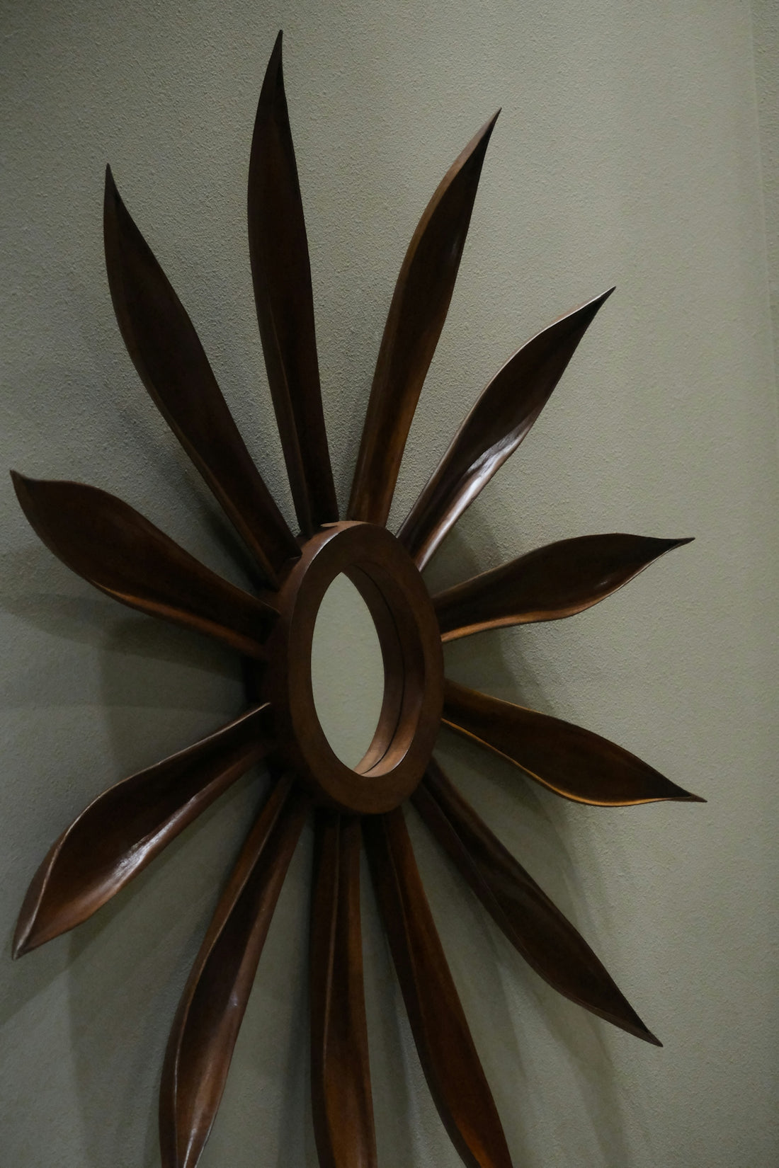 a metal sunburst hanging on a wall