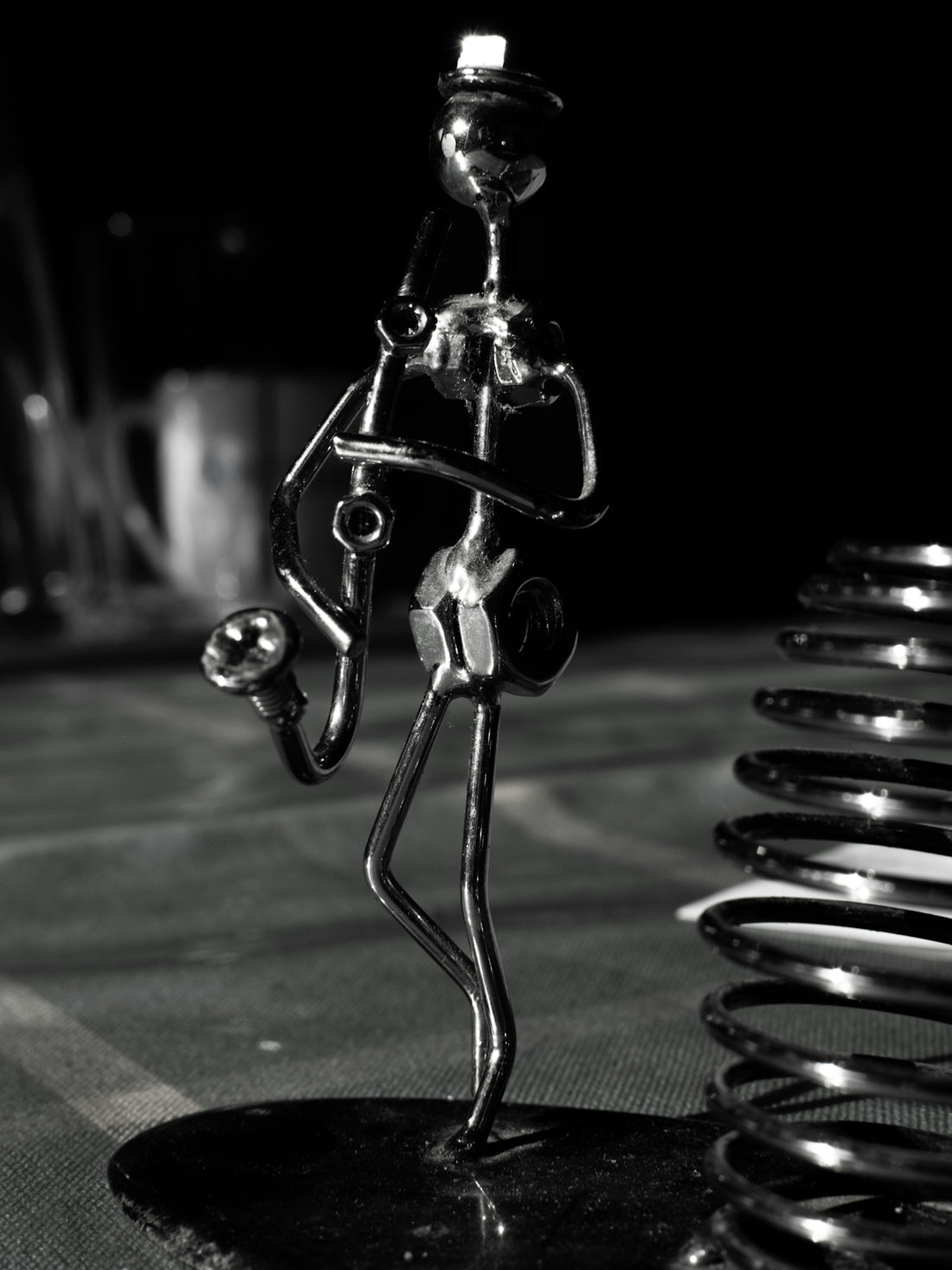 a black and white photo of a metal figure