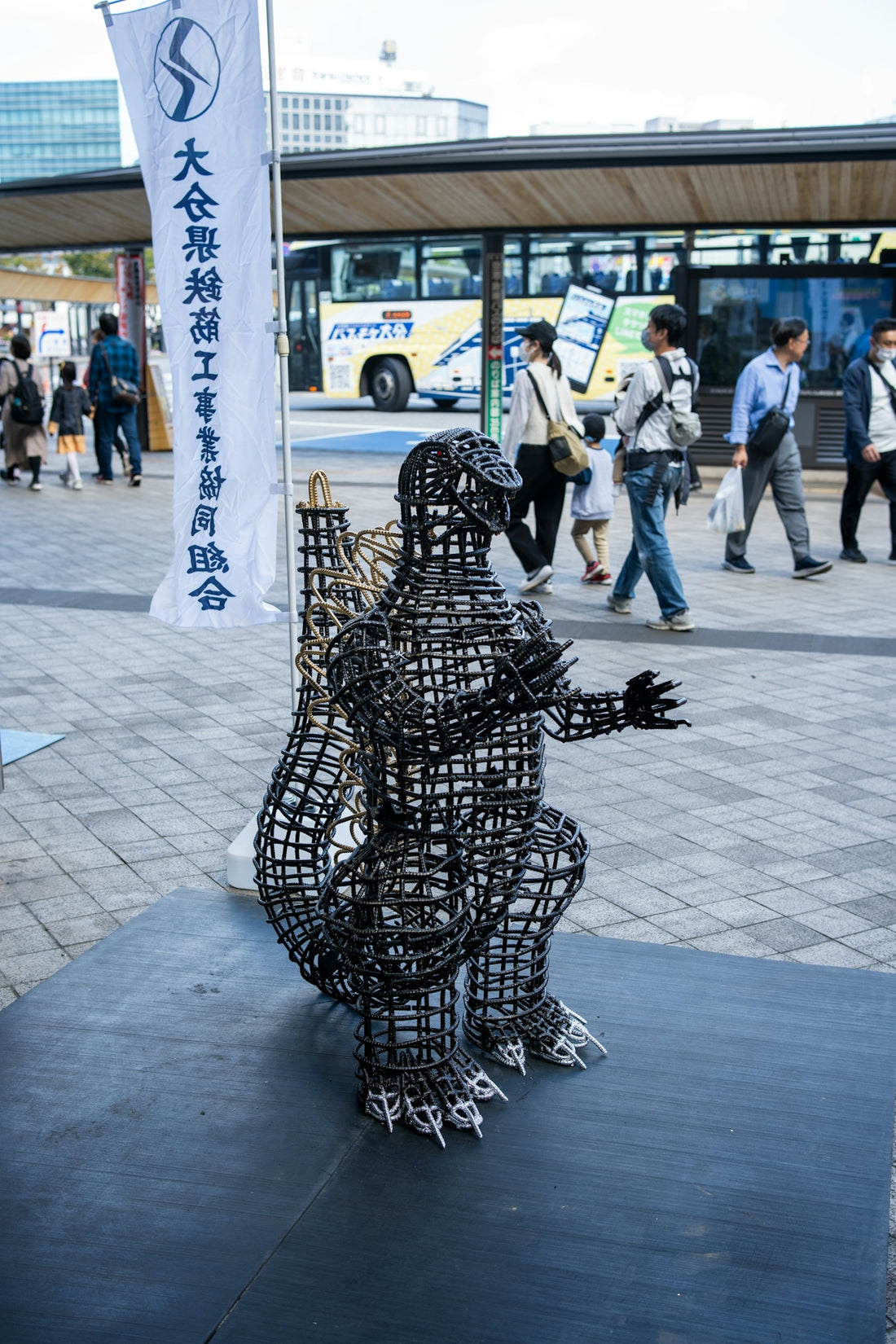 a sculpture of a man with a guitar on a sidewalk