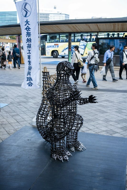 a sculpture of a man with a guitar on a sidewalk