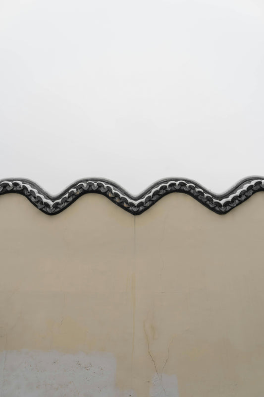 a close up of a metal roof with a white sky in the background