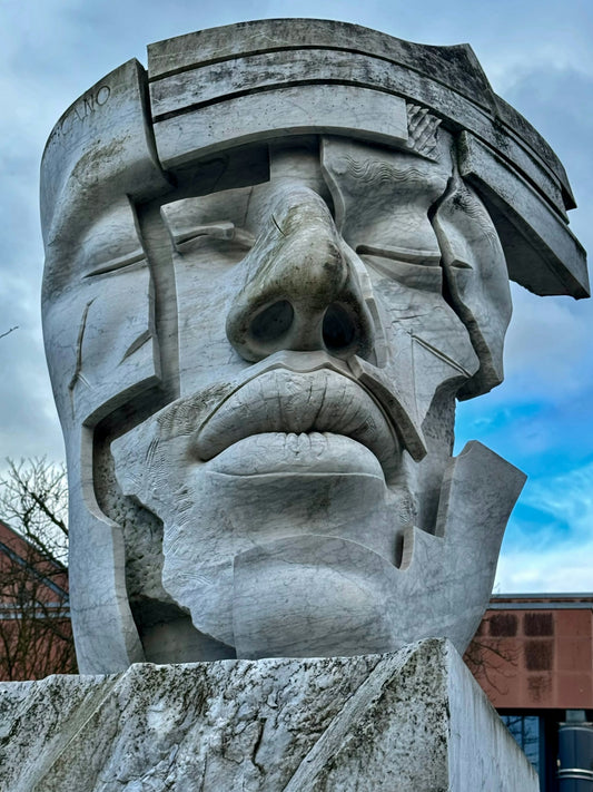 a large statue of a man with a hat on