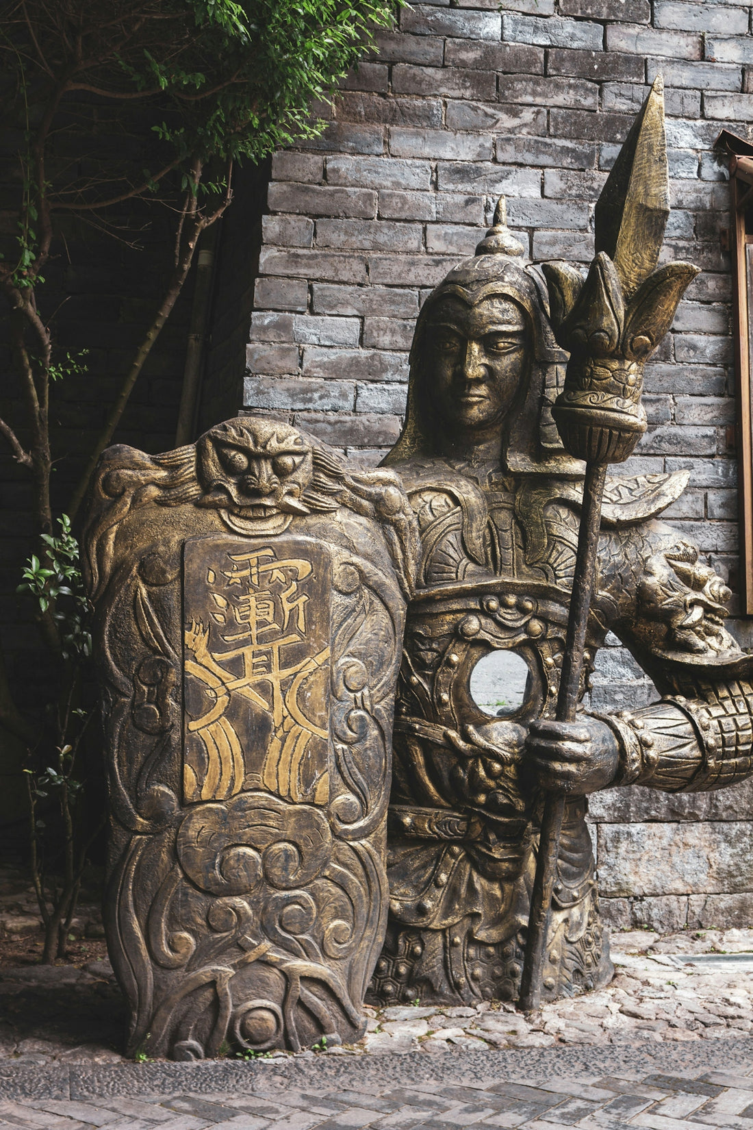 A statue of a man holding a sword and shield