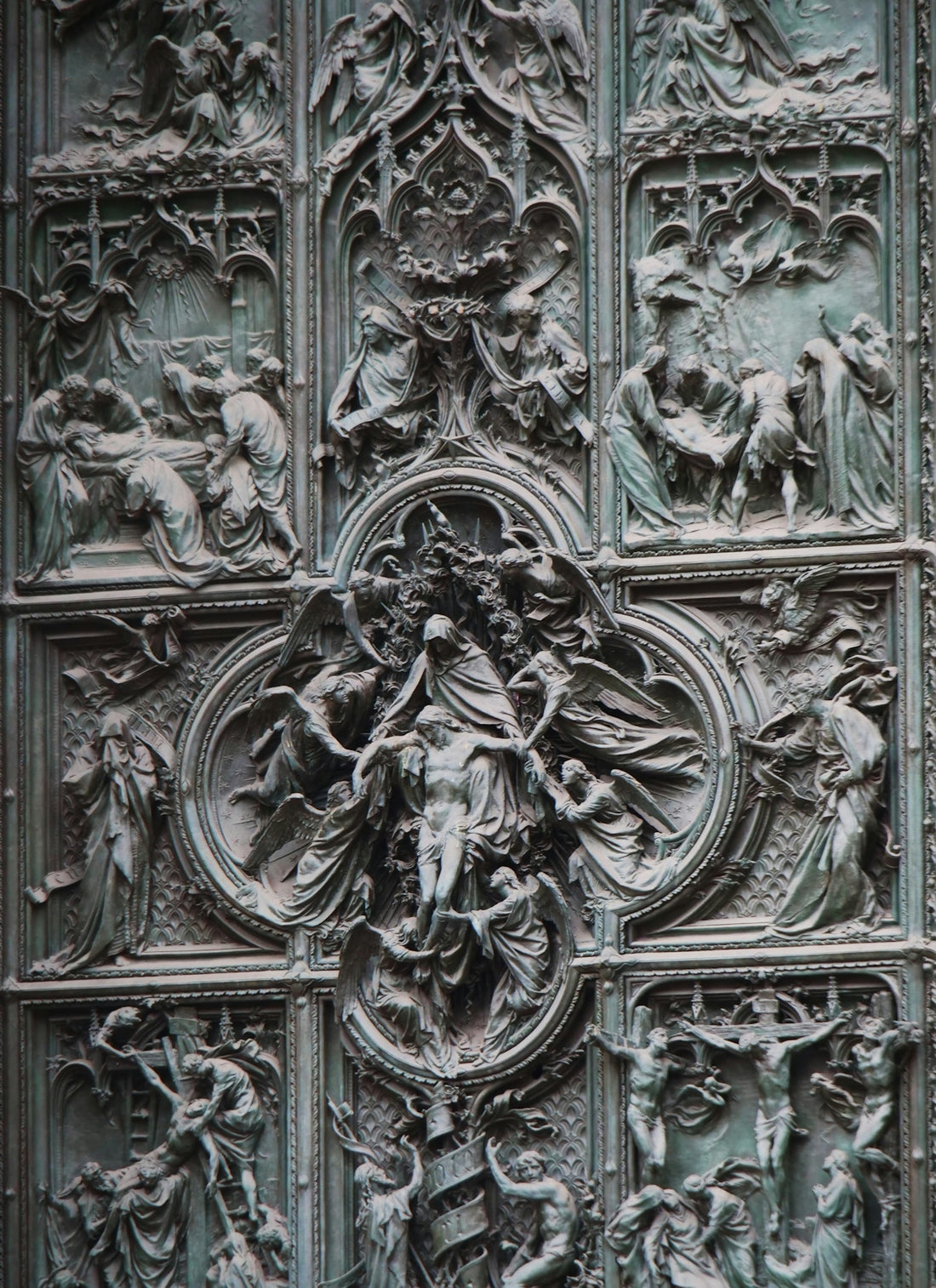 A close up of a metal door with carvings on it
