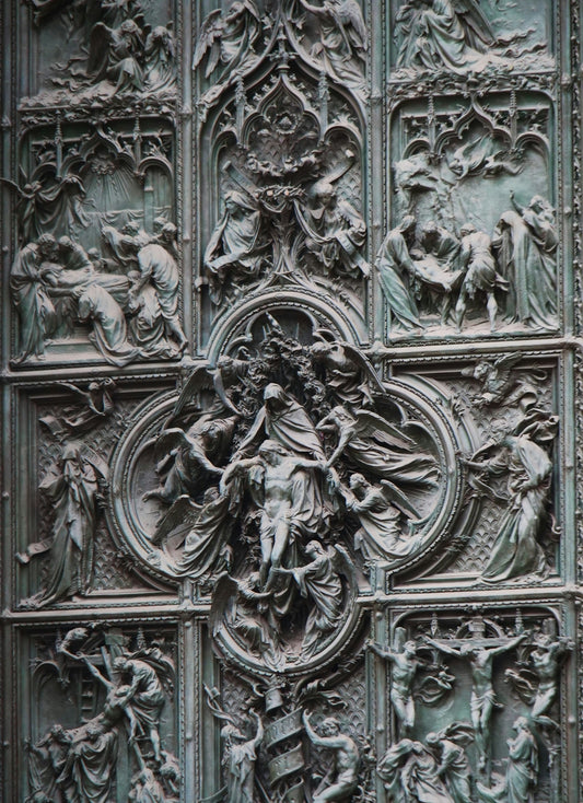 A close up of a metal door with carvings on it