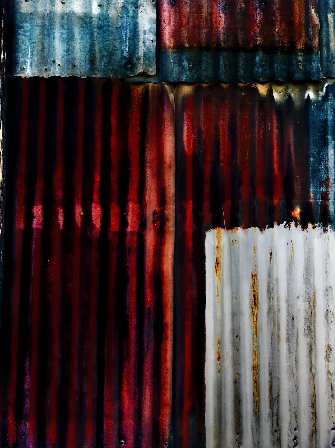 A close up of a rusted metal wall