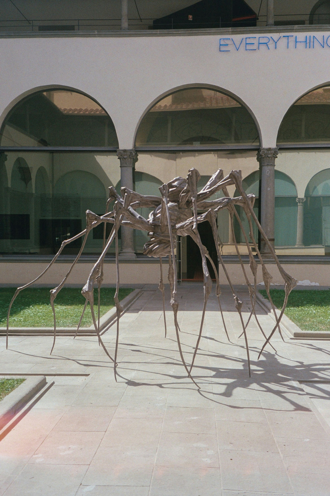 A sculpture of a spider in front of a building