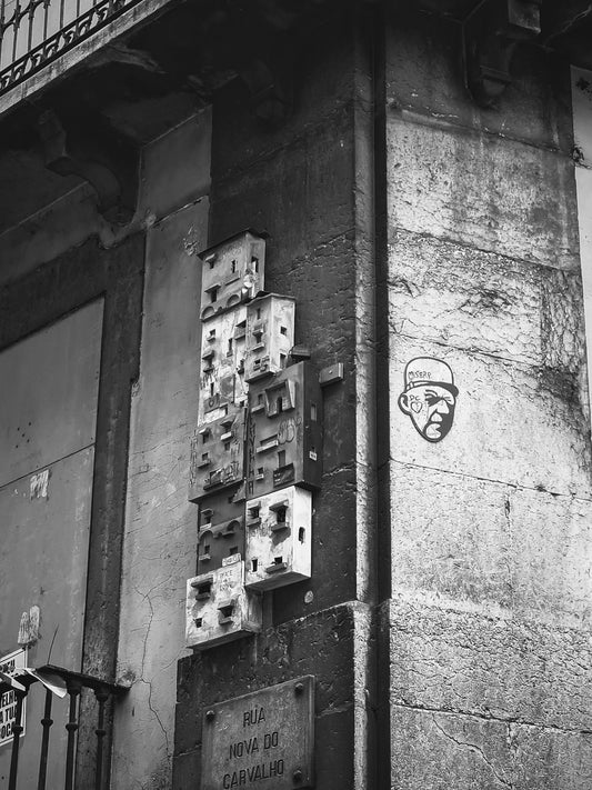 Street art of miniature houses and a face.