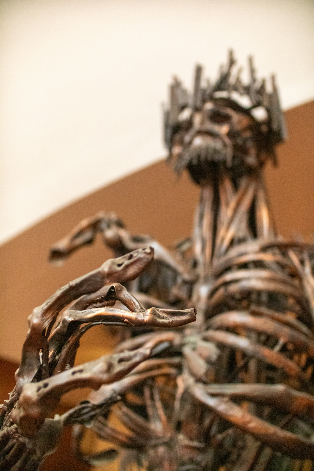 Bronze sculpture of a man with reaching hands.
