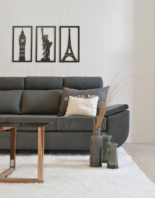 Gray sofa with city landmark art on wall