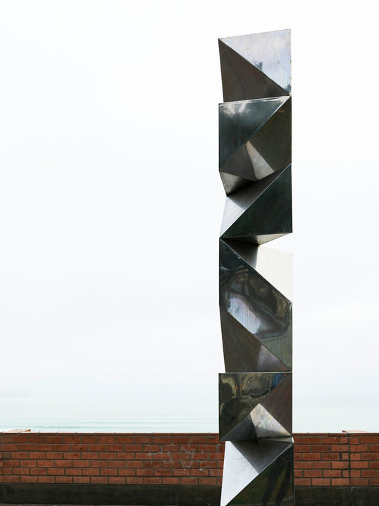 Modern geometric sculpture on brick wall background