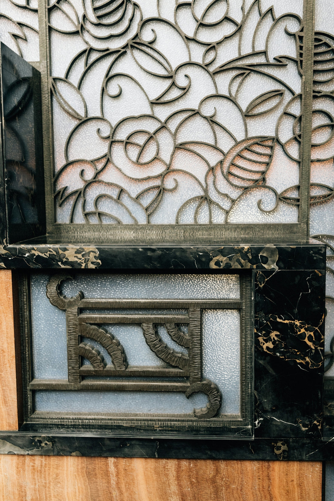 Ornate metal scrollwork on frosted glass panels