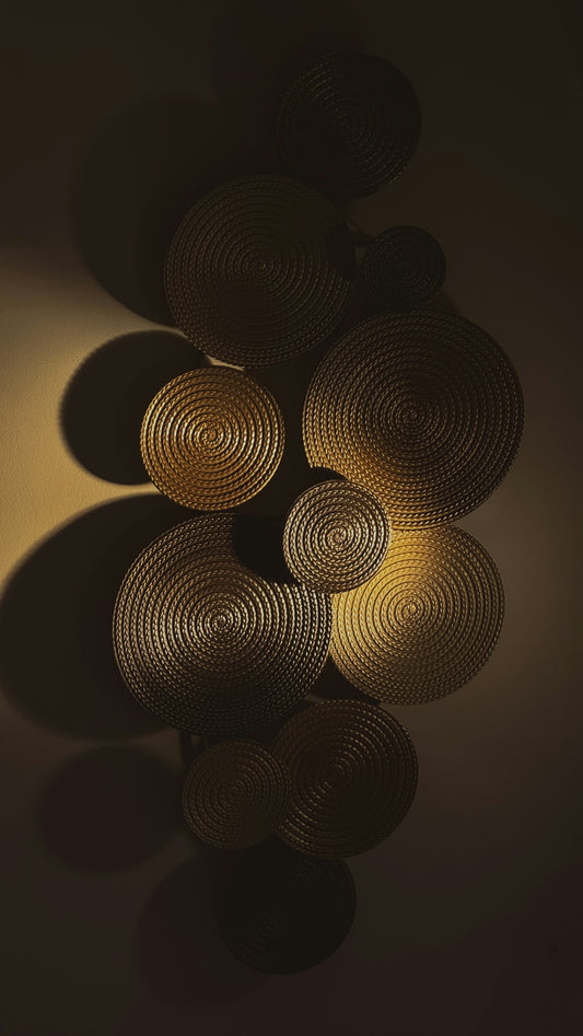 Circular textured wall art with dramatic shadows