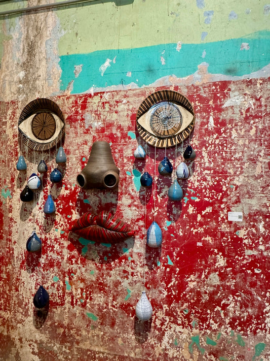 Abstract art installation resembling a face with tears