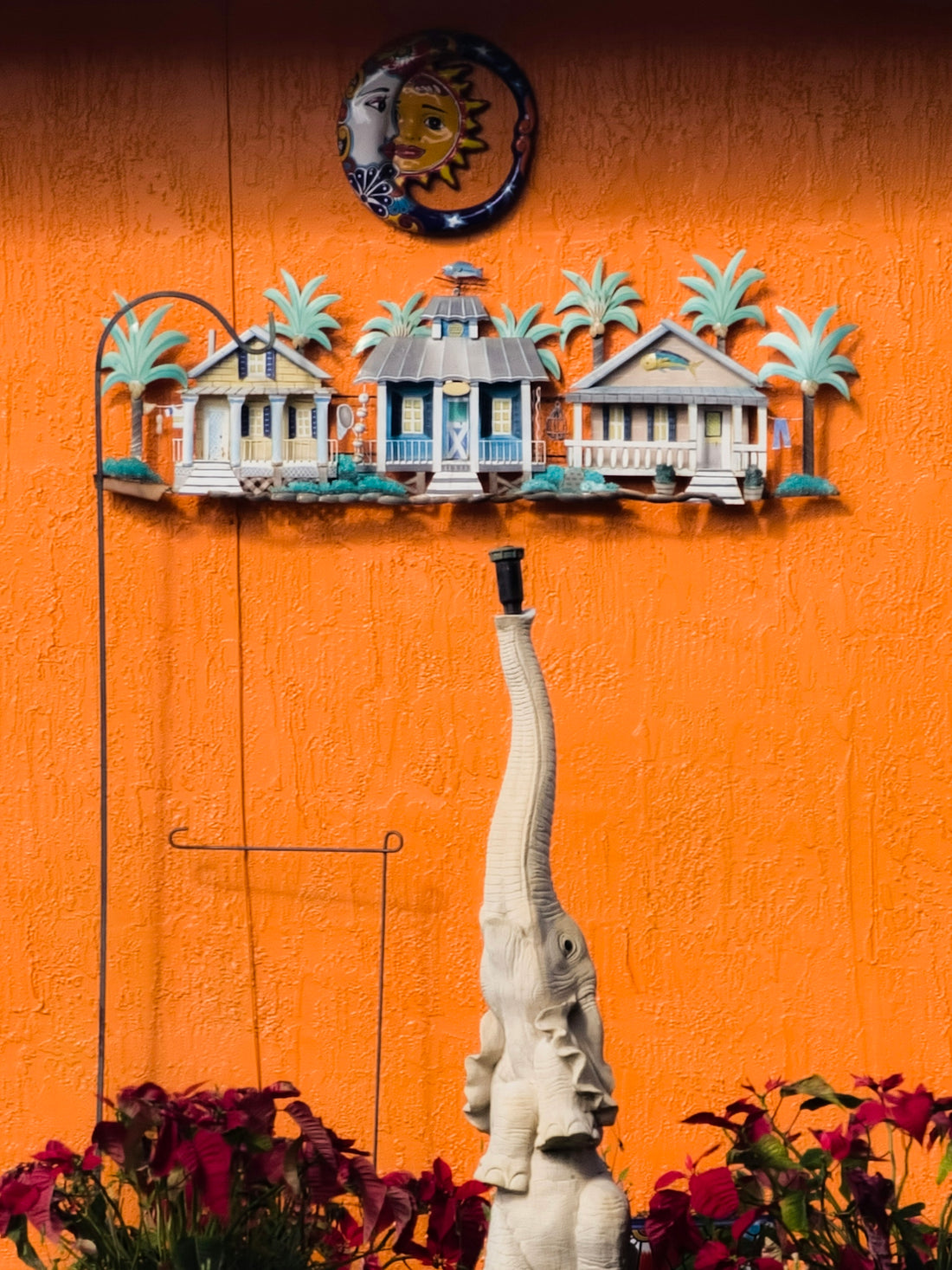 White elephant statue and tropical house decor on orange wall