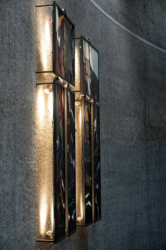 Modern wall sconces illuminate abstract art panels.