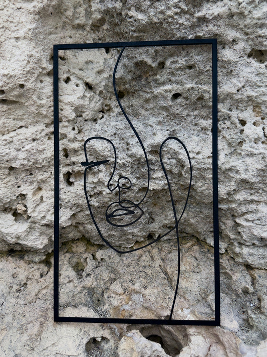 Abstract line art of a face on a stone wall
