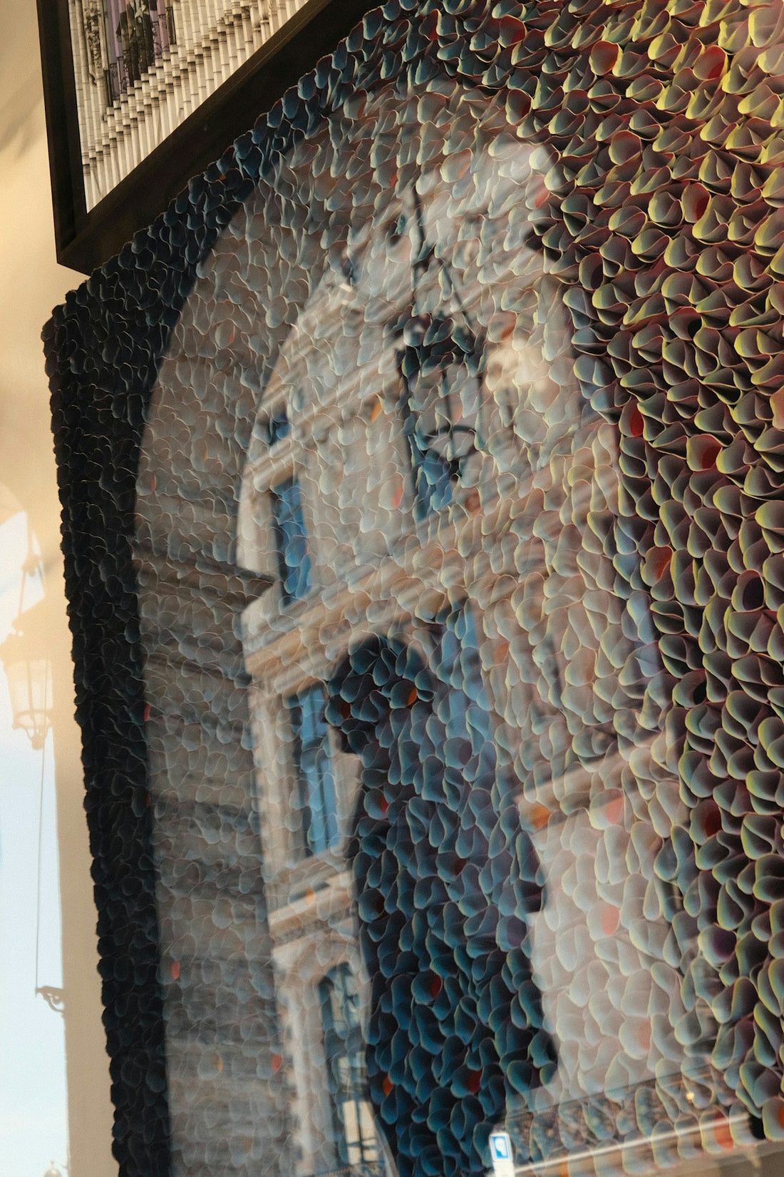 Textured artwork depicting an archway overlooking a historic building.