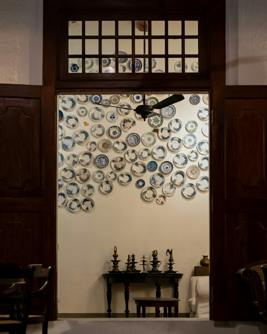 Decorative plates adorn a wall above a console table.